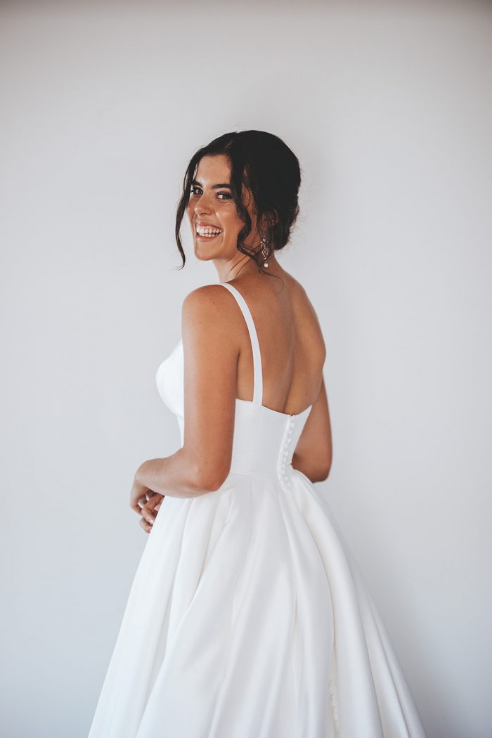 Bride Wearing Classic Wedding Makeup and Modern Satin Bridal Gown Called Selena by Maggie Sottero