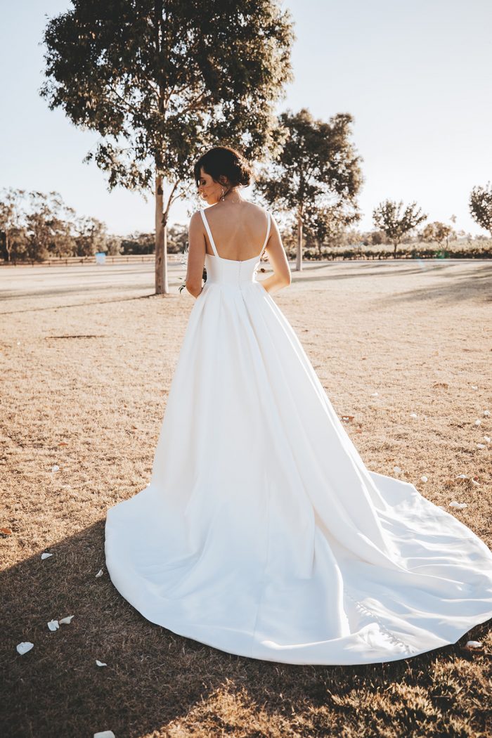 Bride From the Back Wearing Sleeveless Satin Ball Gown Wedding Dress Called Selena by Maggie Sottero
