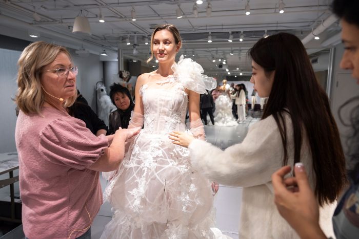 Kelly Midgley and a model wearing a wedding dress designed by Otis students during upcycling mentorship project