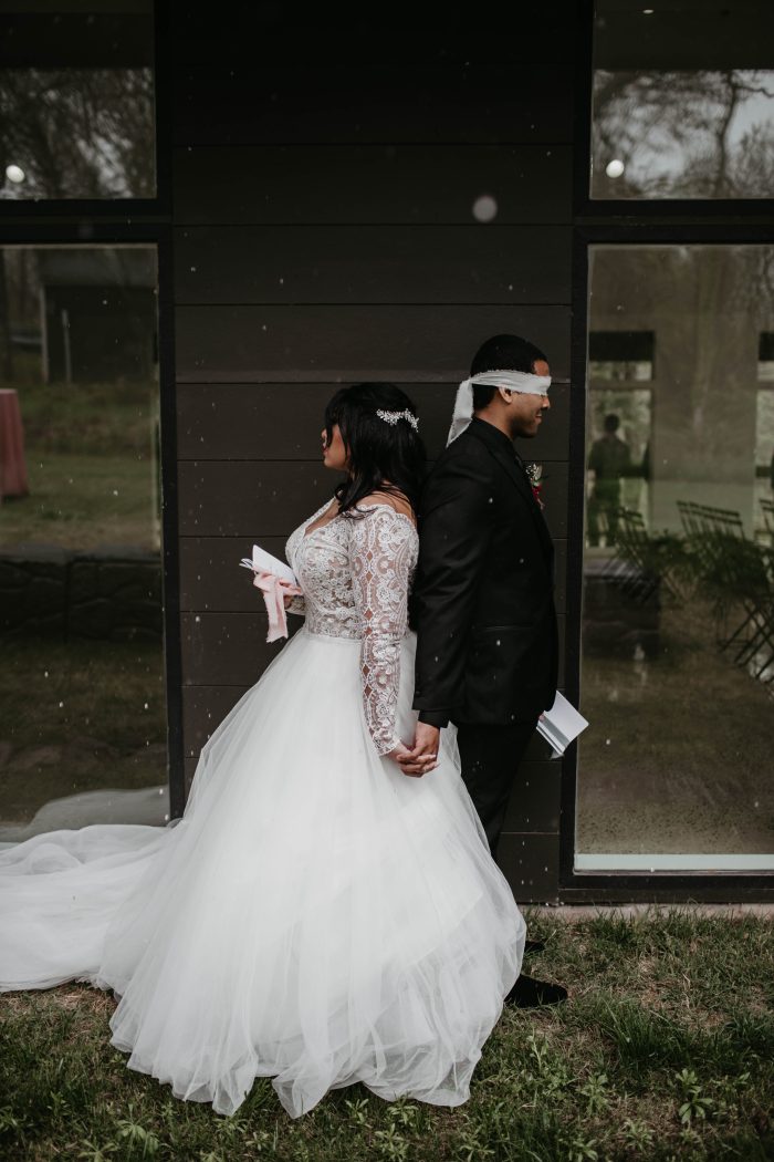 Asian Bride In Long Sleeved Wedding Gown Called Mallory Dawn By Maggie Sottero Walking With Black Husband