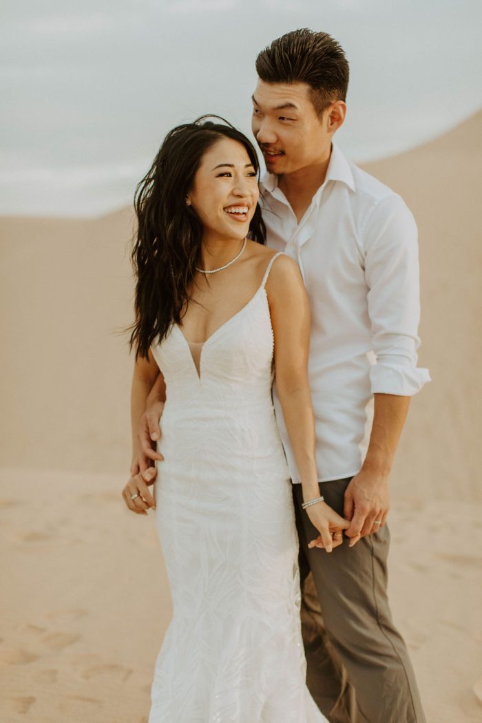 Asian Bride Wearing A Beaded Wedding Dress Called Elsie by Rebecca Ingram In Desert Wedding With Groom