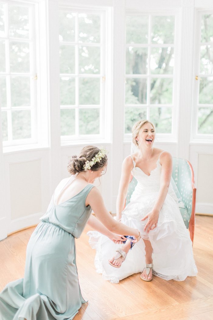 Real Bride Putting on Wedding Day Casual Sandals at Spring Wedding
