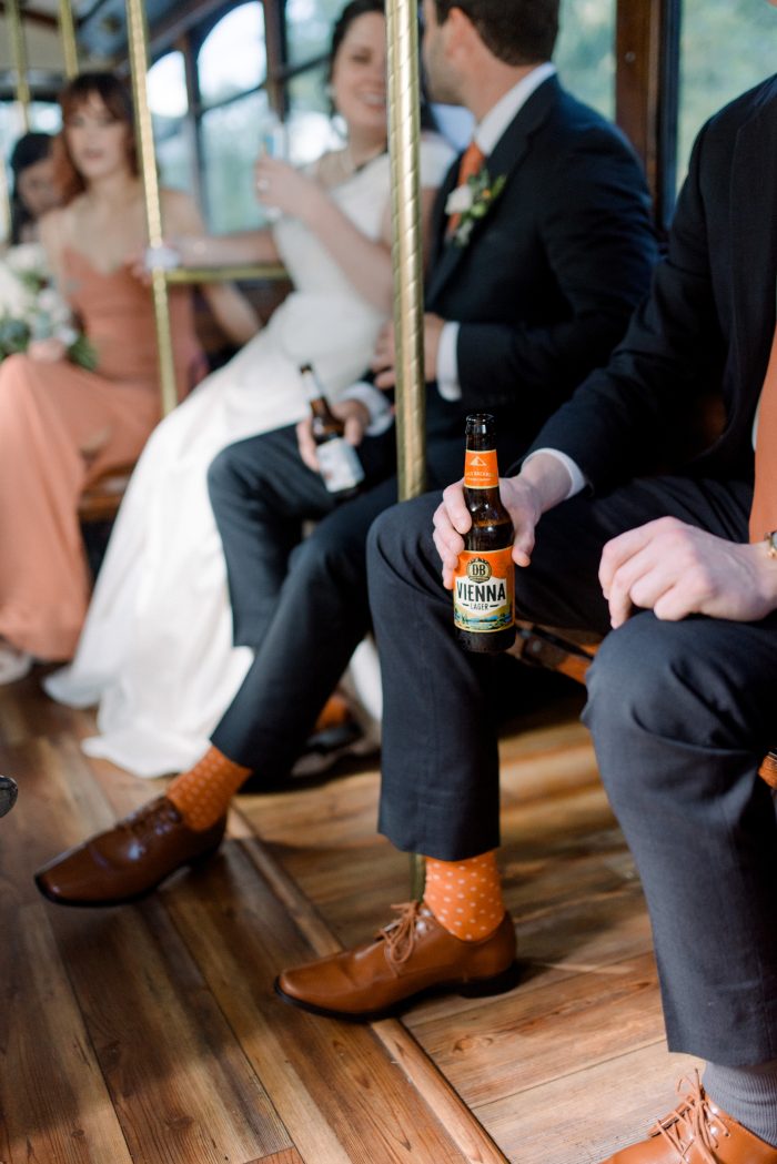 Groomsmen and bridesmaids wearing the Pantone Color of the Year 2024, Peach Fuzz.
