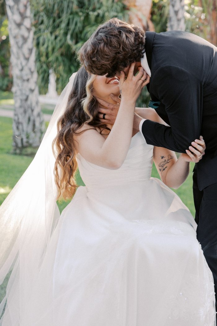Bride in a wheelchair feeling body positive while kissing her husband