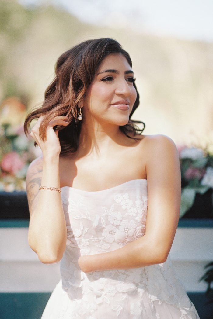 Up close portrait of body confident bride with one hand staring into the distance