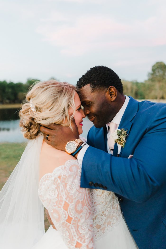 Groom Hugging Real Bride Wearing Lace Ball Gown Wedding Dress Called Mallory Dawn by Maggie Sottero