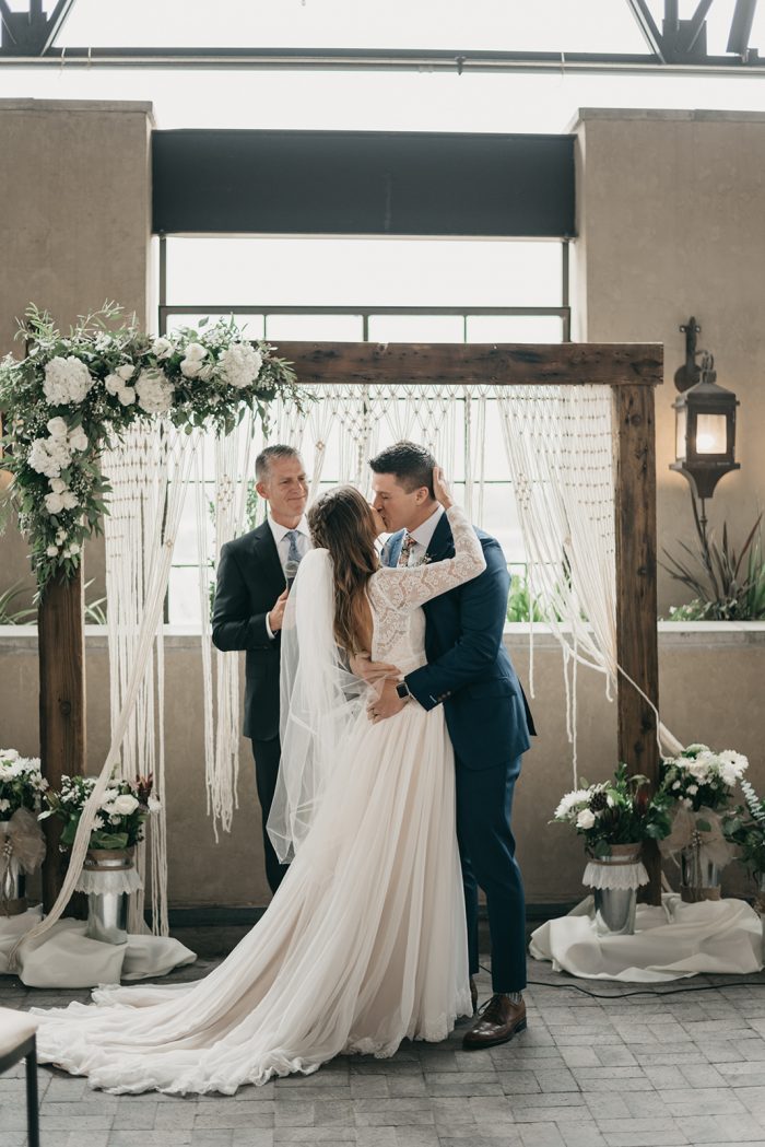 Groom Kissing Real Bride Wearing Lace A-line Wedding Dress Called Deirdre by Maggie Sottero