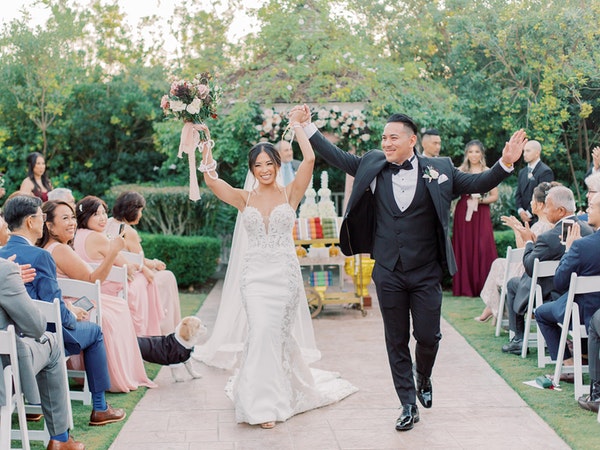 Groom Holding Hands with Real Bride Wearing Wedding Gown Called Darshana by Maggie Sottero2