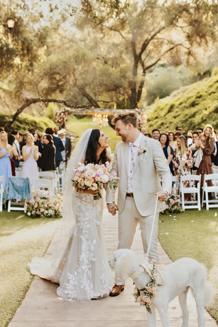 Bride wearing Ivy wedding dress by Maggie Sottero with her husband and dog all wearing the Pantone color of the year 2024.