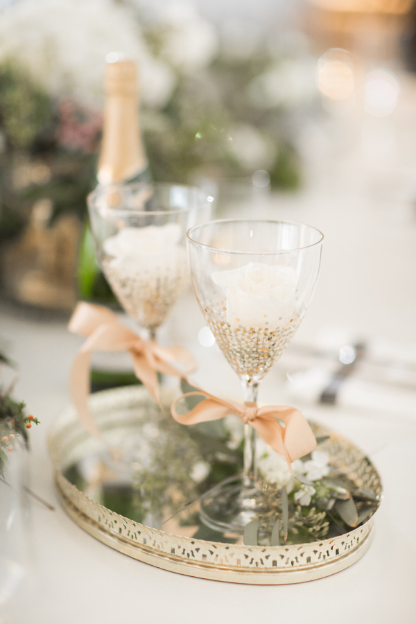 Champaign flutes with bows that are the Pantone Color of the Year 2024, Peach Fuzz.