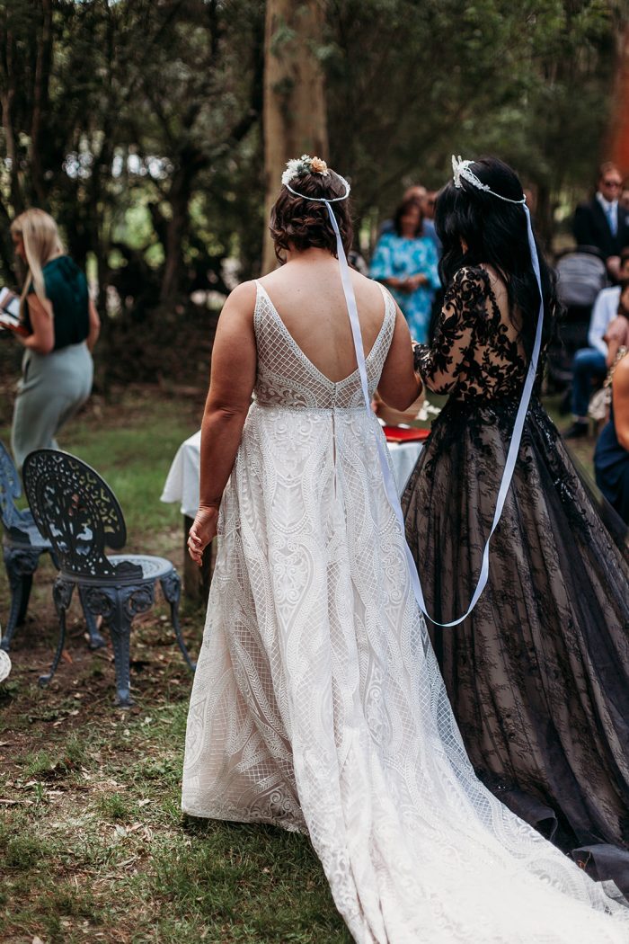 LGBTQ Brides Doing Greek Orthodox Wedding Crowing Ceremony While Wearing Maggie Sottero Wedding Dresses