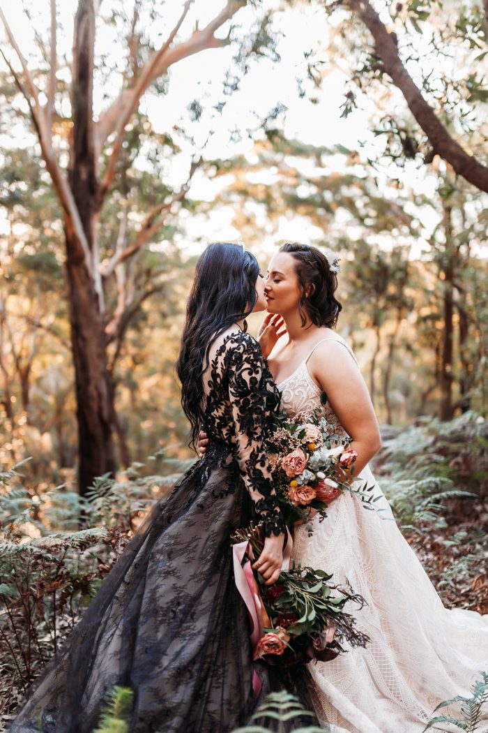 LGBTQ Brides at Fairytale Wedding Wearing Contrasting Black and Ivory Wedding Dresses by Maggie Sottero
