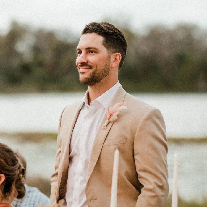 Groom Wearing Tan Suit at Lakeside Wedding