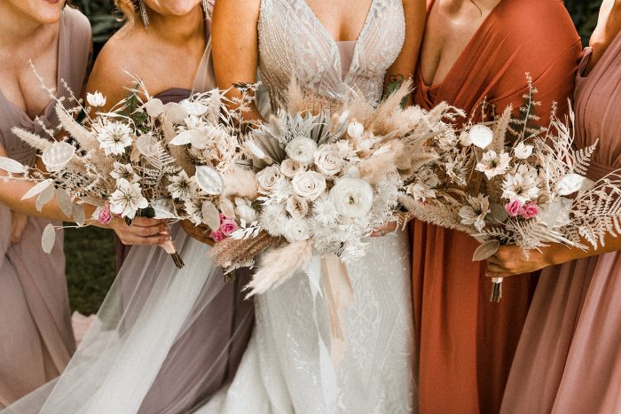 Bride and Bridesmaids Holding Modern Boho Wedding Bouquets at Lakeside Wedding