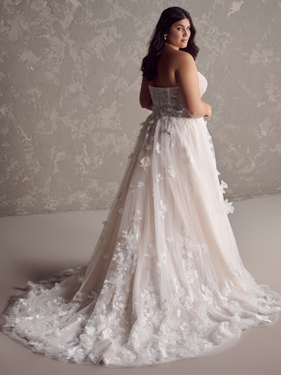 Curve bride wearing an A-line floral wedding gown