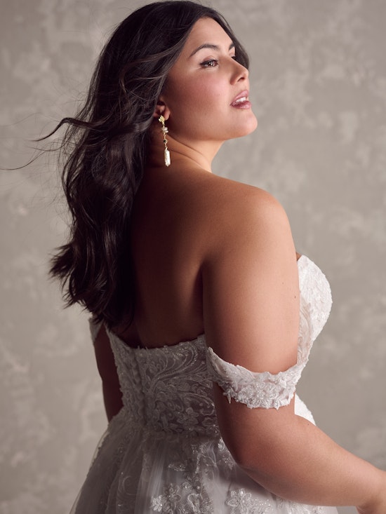 Bride wearing pearl wedding dress called Marguerite by Maggie Sottero