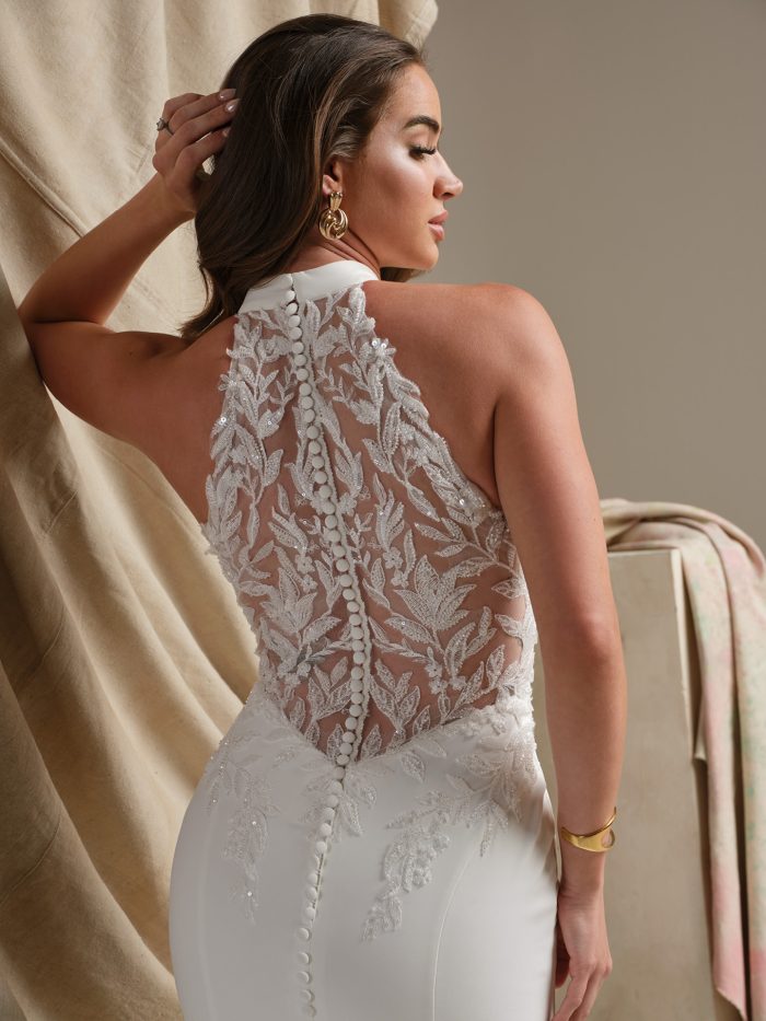 Back view of the Spokane sheath wedding dress highlighting the illusion lace back with botanical appliqués, satin-covered buttons, and the smooth fitted silhouette.