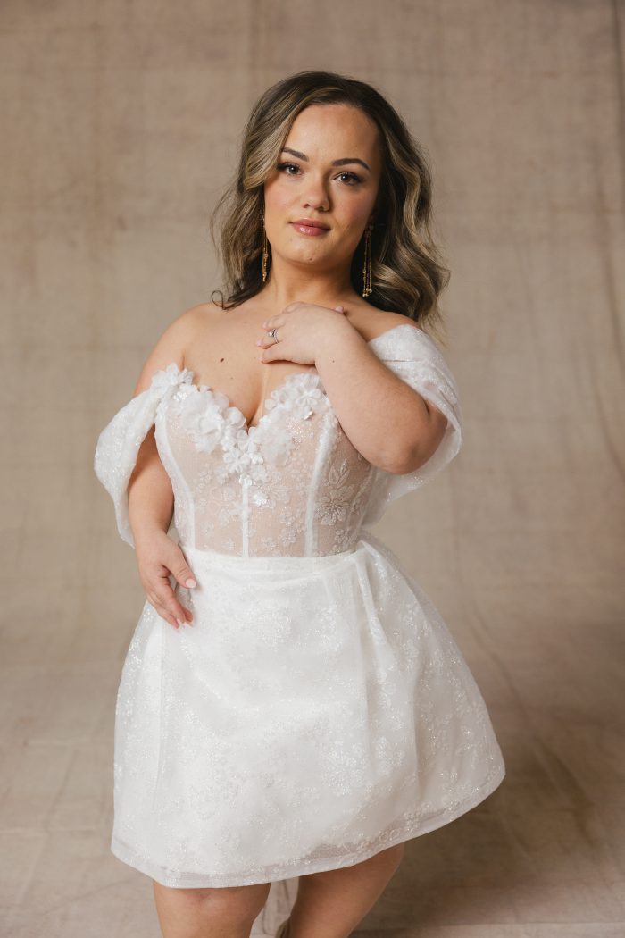 Little person bride wearing a sweetheart neckline wedding dress with floral details
