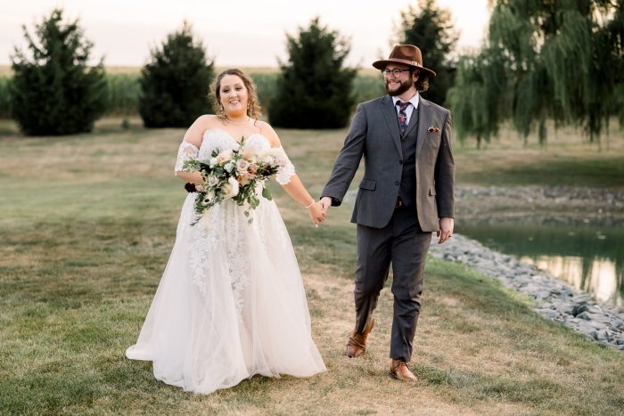 Bride walking hand-in-hand with her husband.
