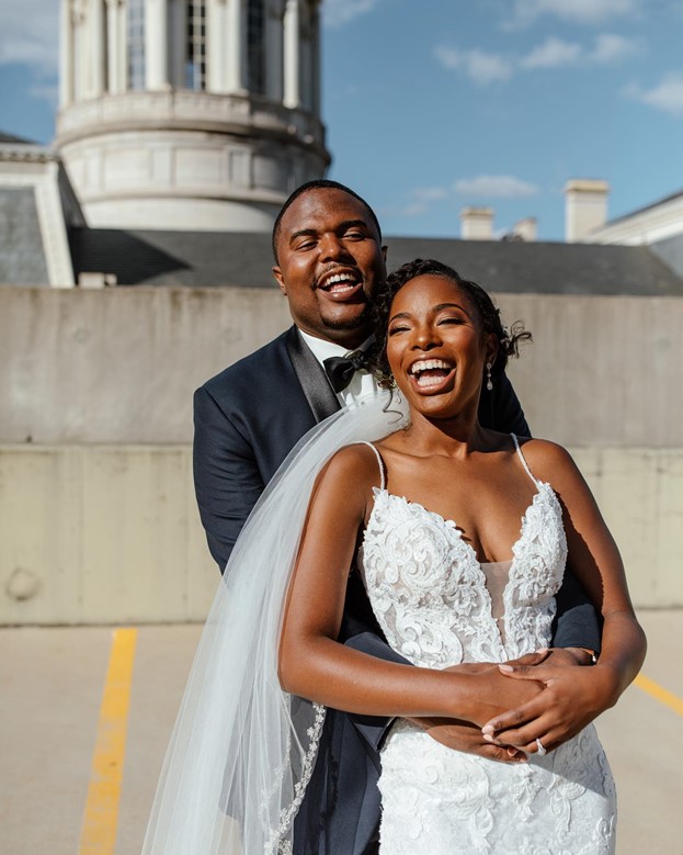 Bride wearing Tuscany Lynette Lace Mermaid wedding dress by Maggie Sottero and Groom laughing together