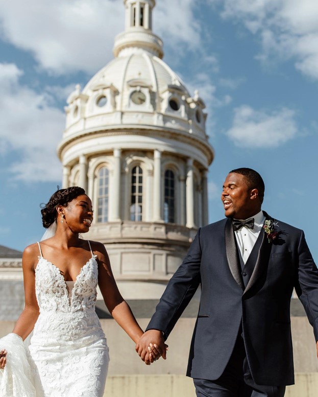 Bride wearing Tuscany Lynette Lace Mermaid wedding dress by Maggie Sottero and Groom Holding hands