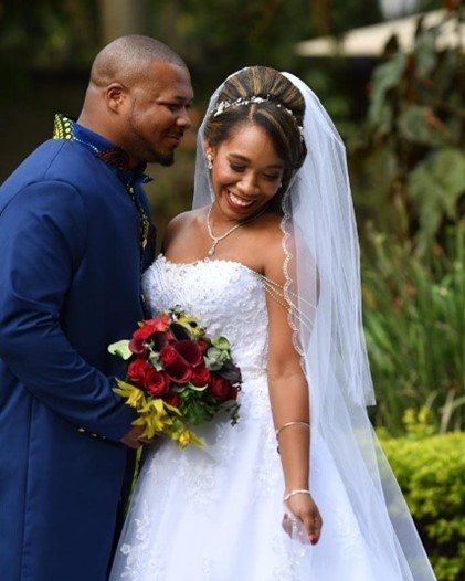 Real Bride and Groom with bride wearing a Maggie Sottero gown in a garden wedding