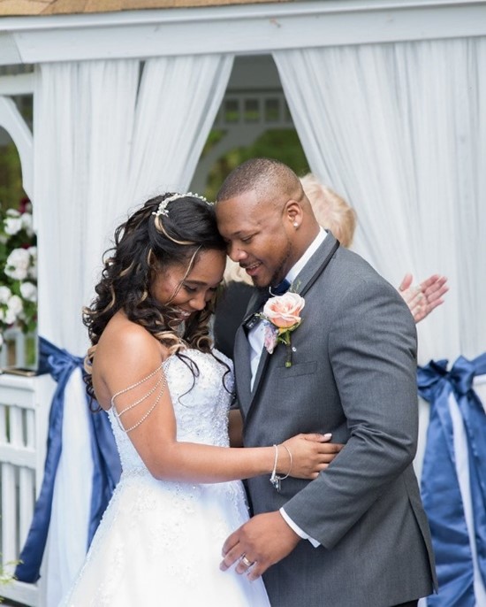 Real Bride and Groom with bride wearing a Maggie Sottero gown in a garden wedding