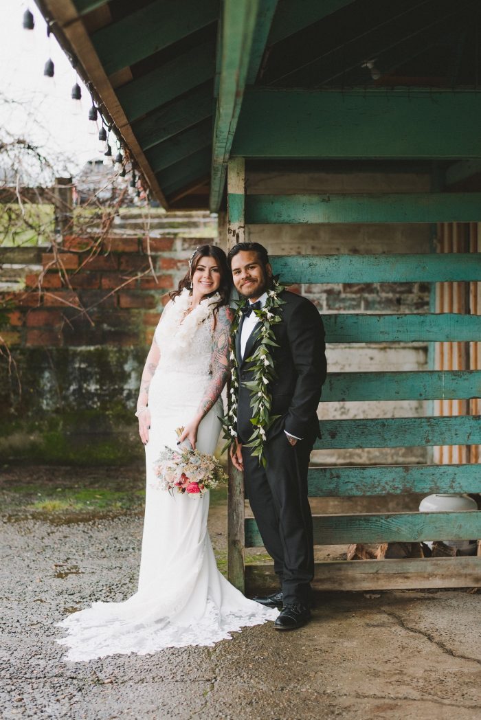 Real Bride Wearing Beaded Sheath Wedding Dress and Groom Wearing Leis at Wedding
