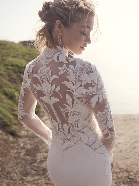Bride wearing a lace bridal jacket with buttons all the way up