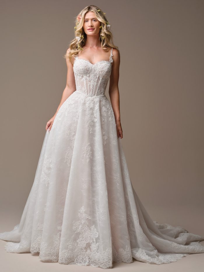 Esmeralda by Rebecca Ingram A-line wedding dress featuring corded lace motifs over Chantilly lace and sequin tulle with a sweetheart neckline and full skirt
