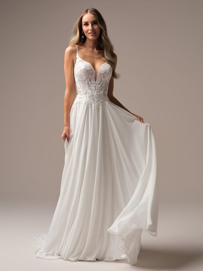 Bride spinning in a chiffon A-line wedding dress