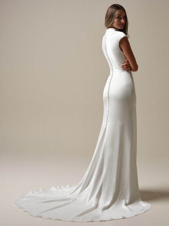 Bride wearing vintage simple wedding gown with buttons down the train