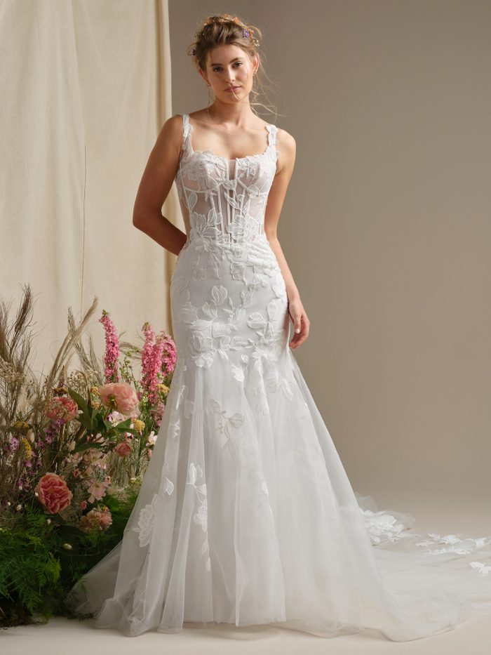 Rebecca Ingram Pearline fit-and-flare wedding dress with illusion corset bodice, exposed boning, lace tank straps, and lace motifs over soft tulle.