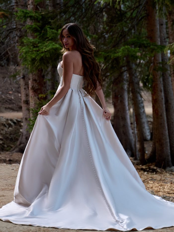 Bride wearing Aspen by Sottero and Midgley, a simple A-line Mikado wedding dress with a cat eye neckline