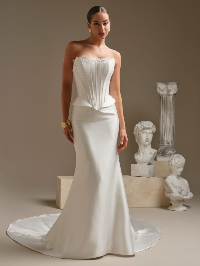 Front view of the Lassen Marie two-piece wedding gown featuring a structured strapless corset bodice with clean vertical lines and a fitted satin skirt with a soft train.