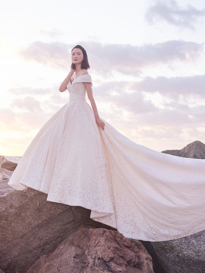 Model Wearing Off-the-Shoulder Classic Ball Gown Wedding Dress Called Thomas by Sottero and Midgley