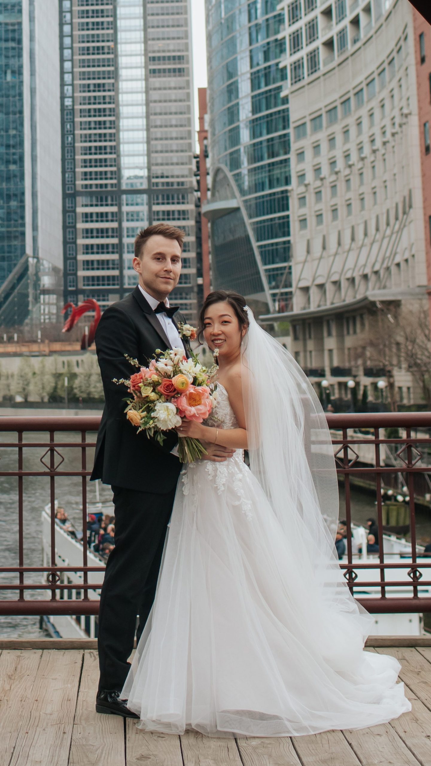 Bride wearing Stevie wedding dress by Maggie Sottero and holding a Pantone Color of the Year 2024 bouquet. 