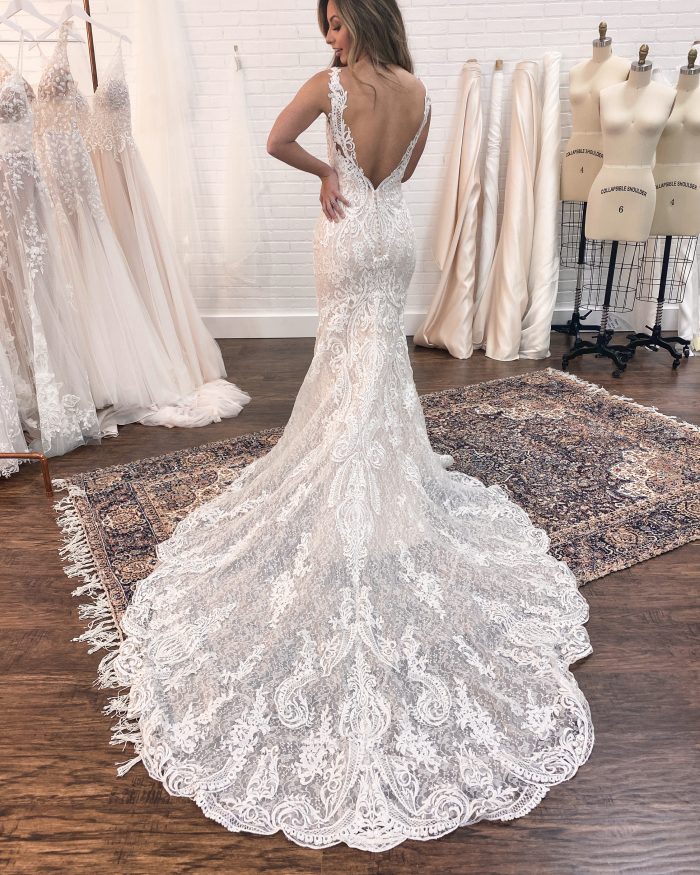 Bride Showing the Back of Her Maggie Sottero Wedding Dress Train at Wedding Dress Fitting