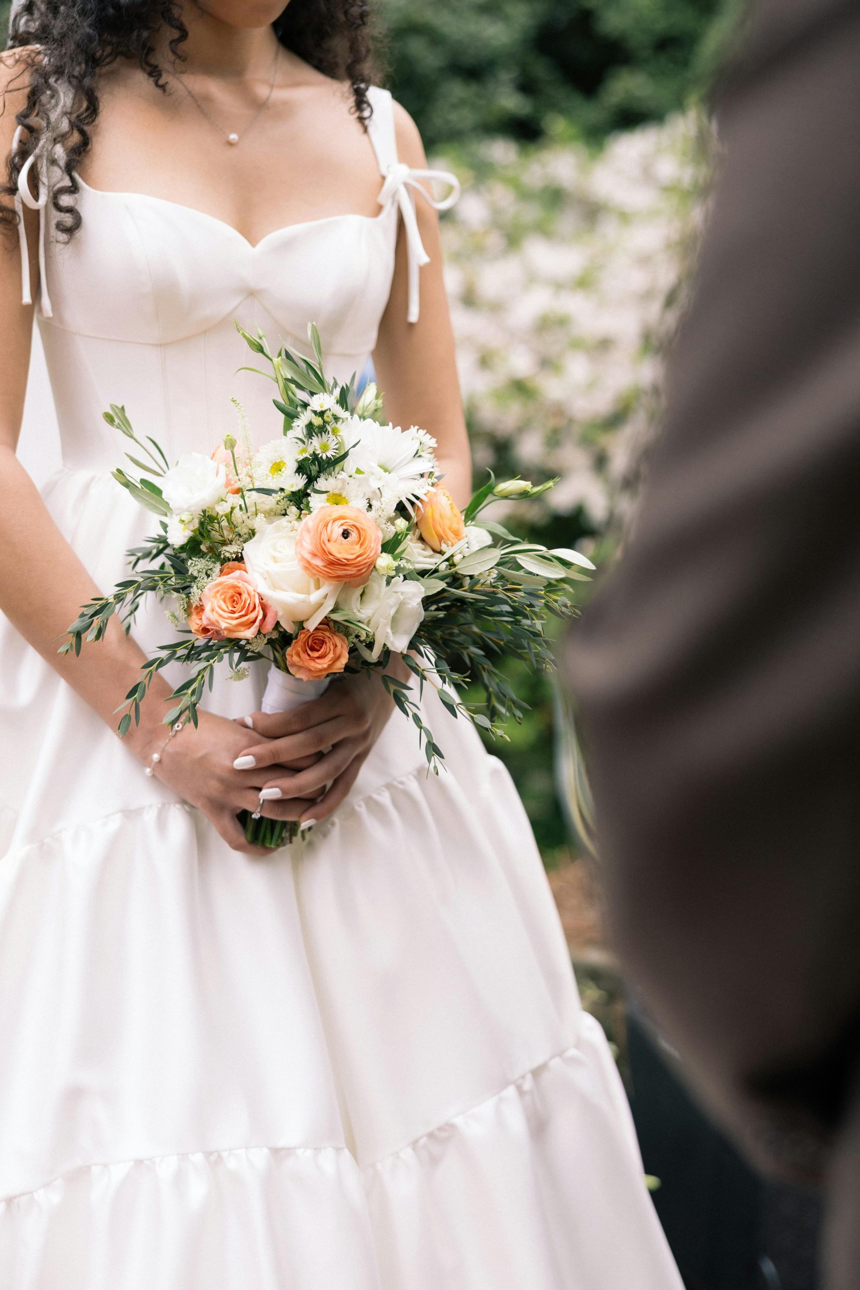 Bride wearing Talitha by Sottero and Midgley standing in front of her groom receiving wedding vows