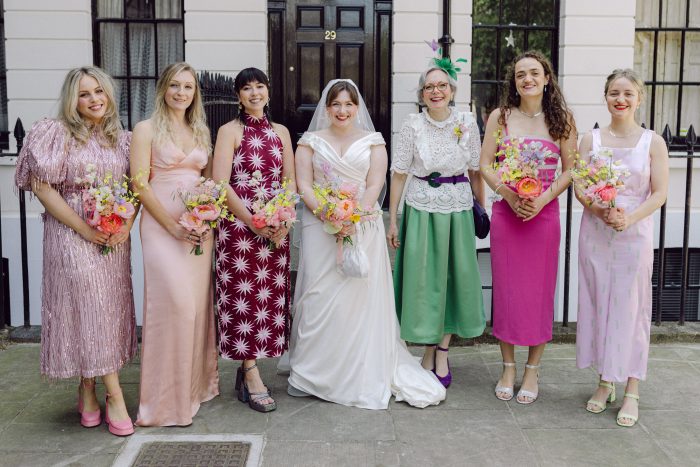 Bride wearing Tenley by Maggie Sottero surrounded by bridesmaids in mismatching dresses as a new wedding tradition