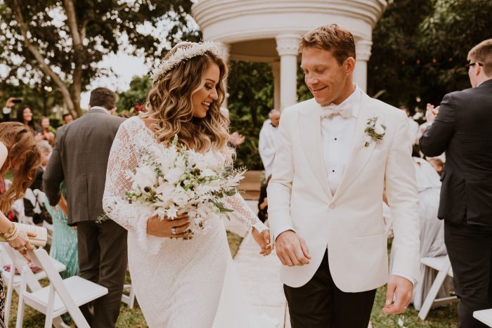 Bride and Groom Walking Down the Aisle after Catholic Wedding Ceremony