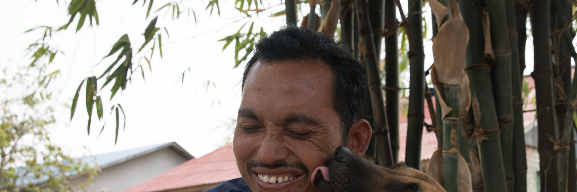 Caretaker Sary Dit with rescued dog