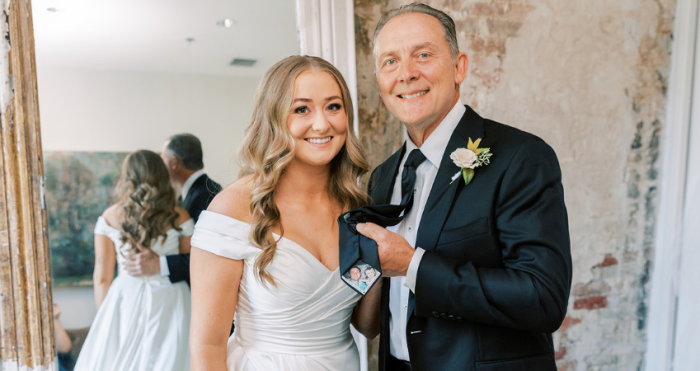 Bride wearing Ekaterina by Maggie Sottero next to her father figure