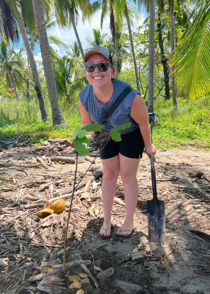 Maggie Sottero employee planting a tree