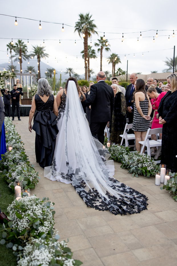 Curly walking down the aisle, wearing Tristyn wedding gown by Maggie Sottero, at her New Year's Eve wedding